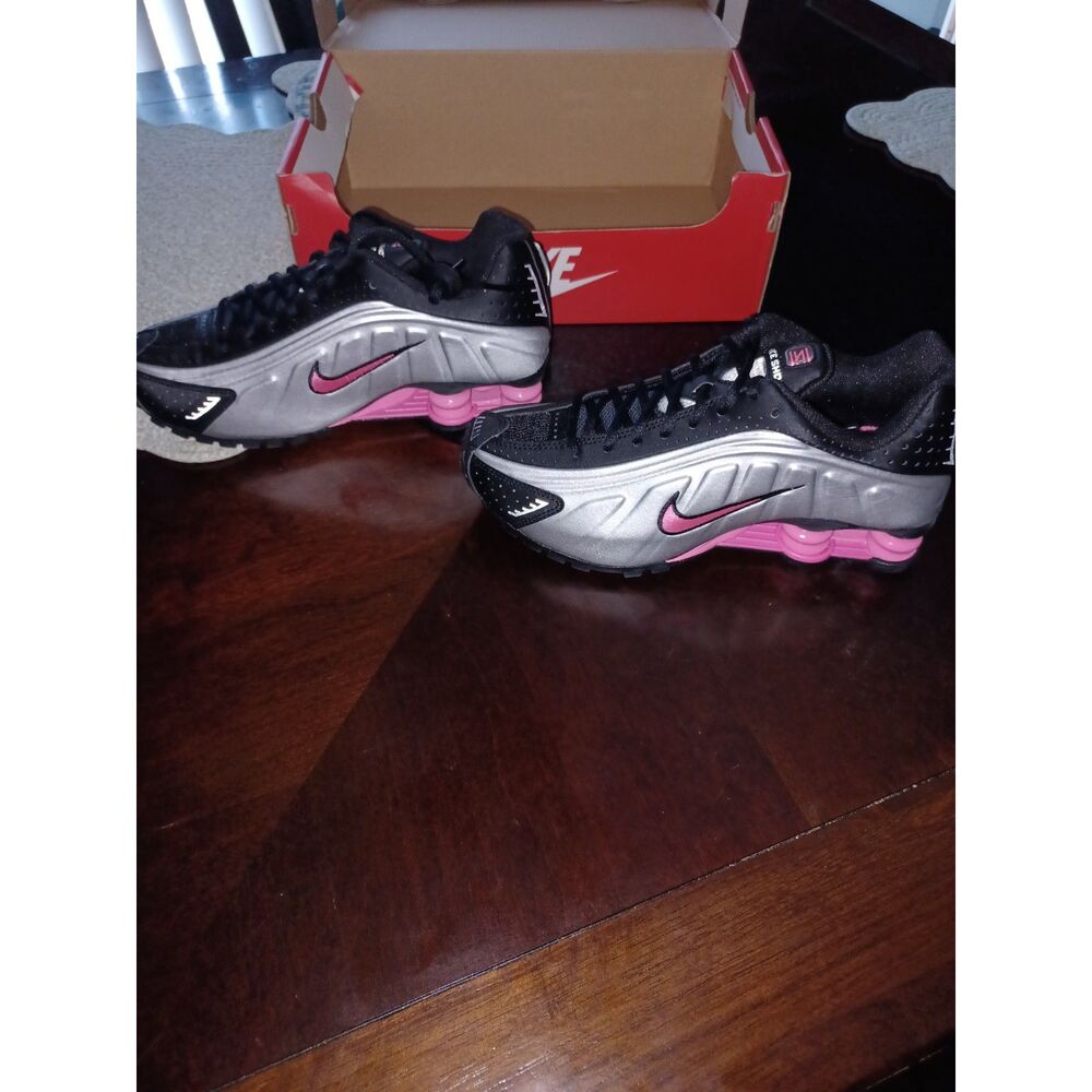 Nike Shox R4 sneakers in a black and metallic silver colorway with pink accents